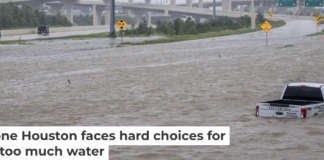 A roadside assistance vehicle is swamped by floodwaters on a Houston highway in 2024. Brandon Bell/Getty Images